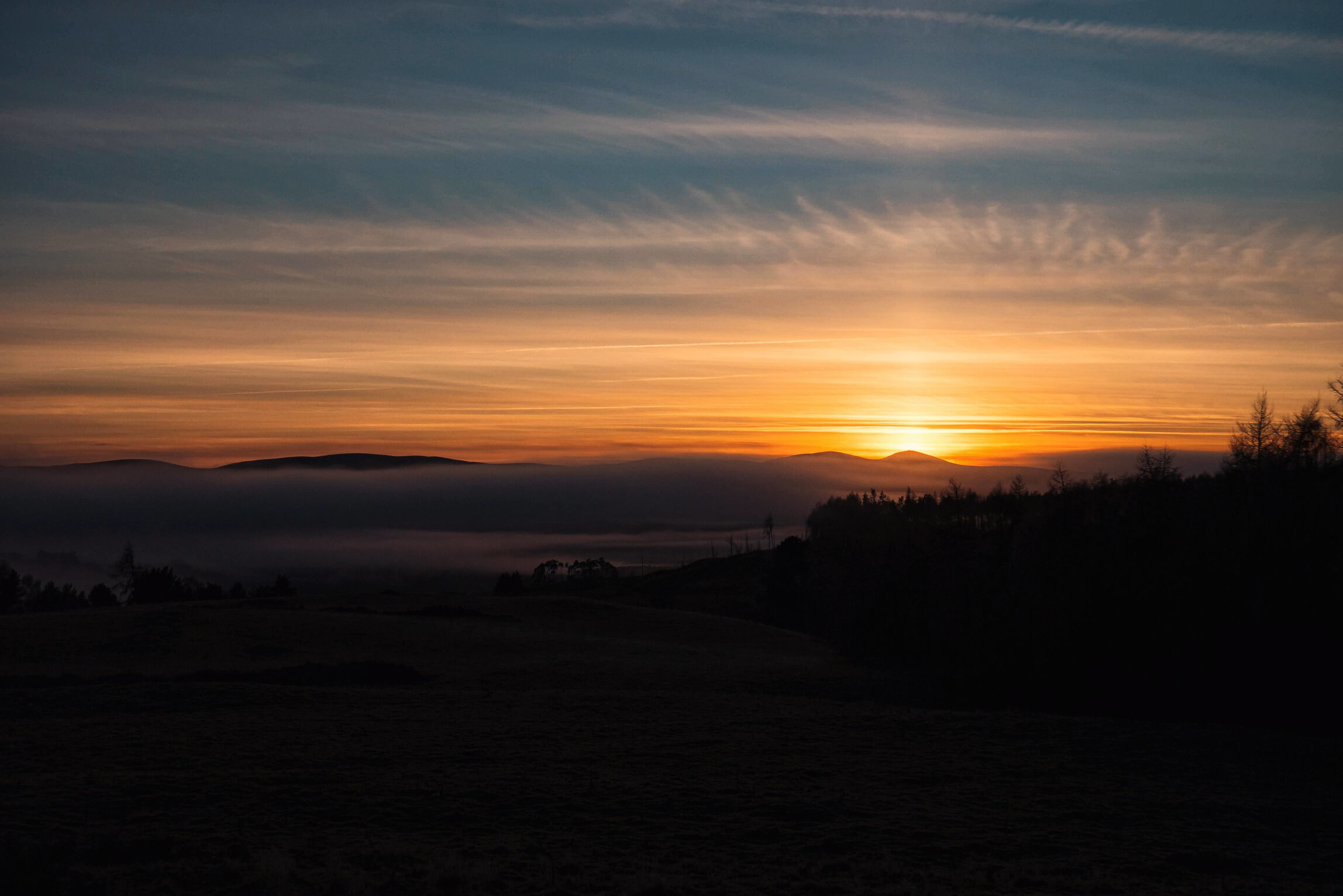 Foggy Hillside Sunset